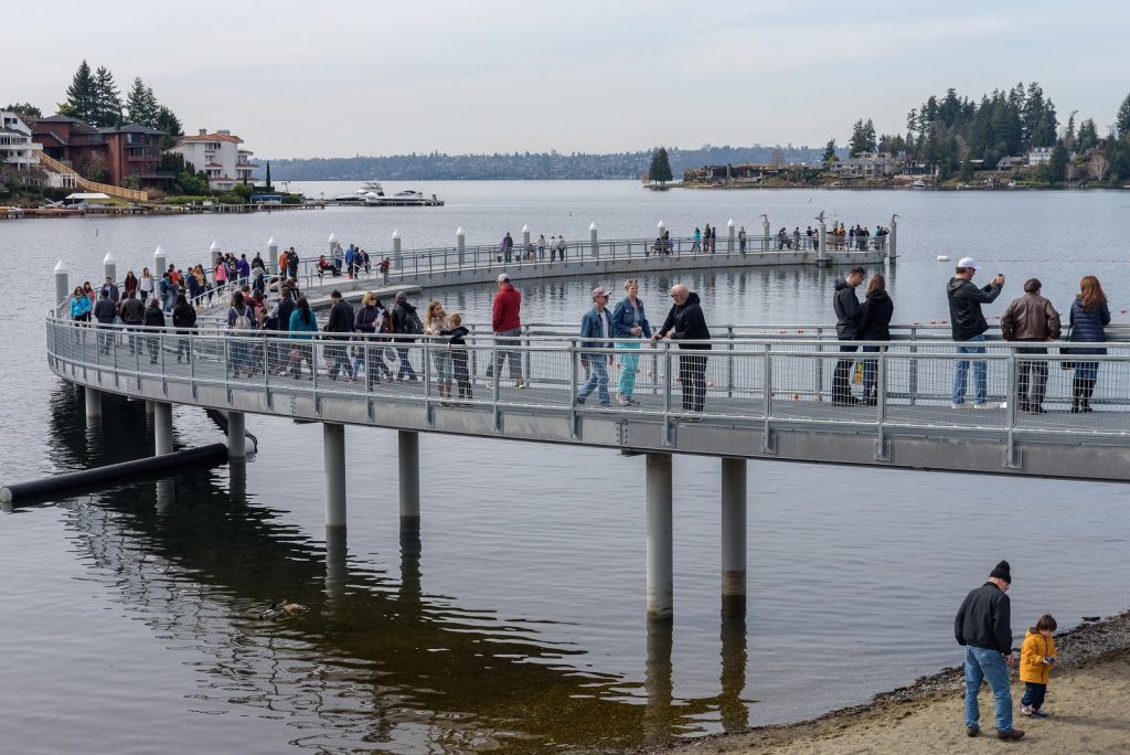 people on footbridge over waterfront