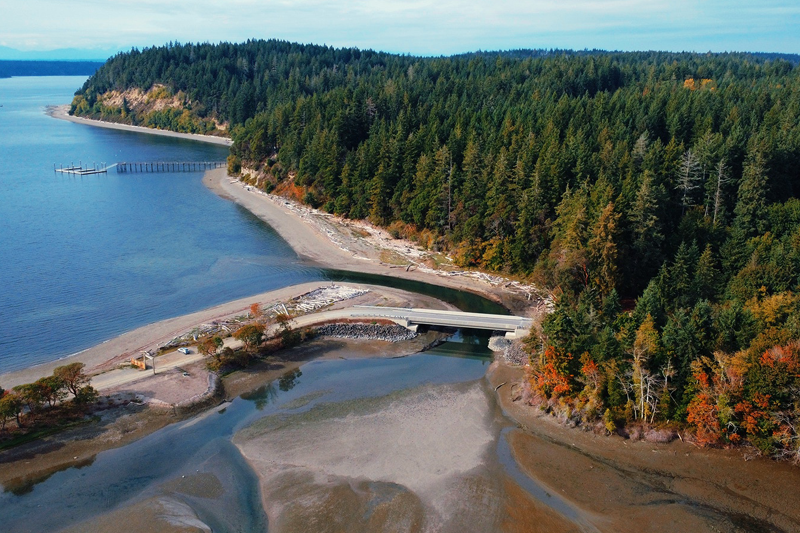 Aerial of a coastline with bridge: Whitman cove